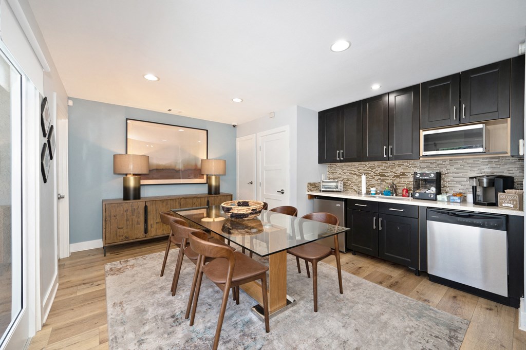 a kitchen and dining room with a table and chairs
