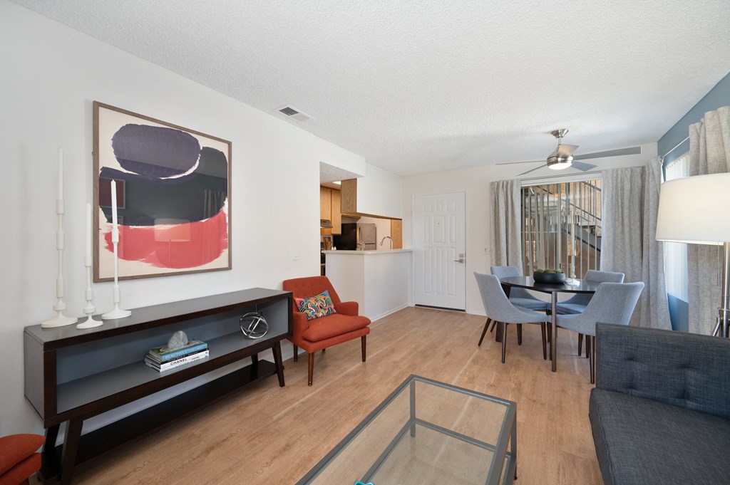 a living room and dining room with a table and chairs