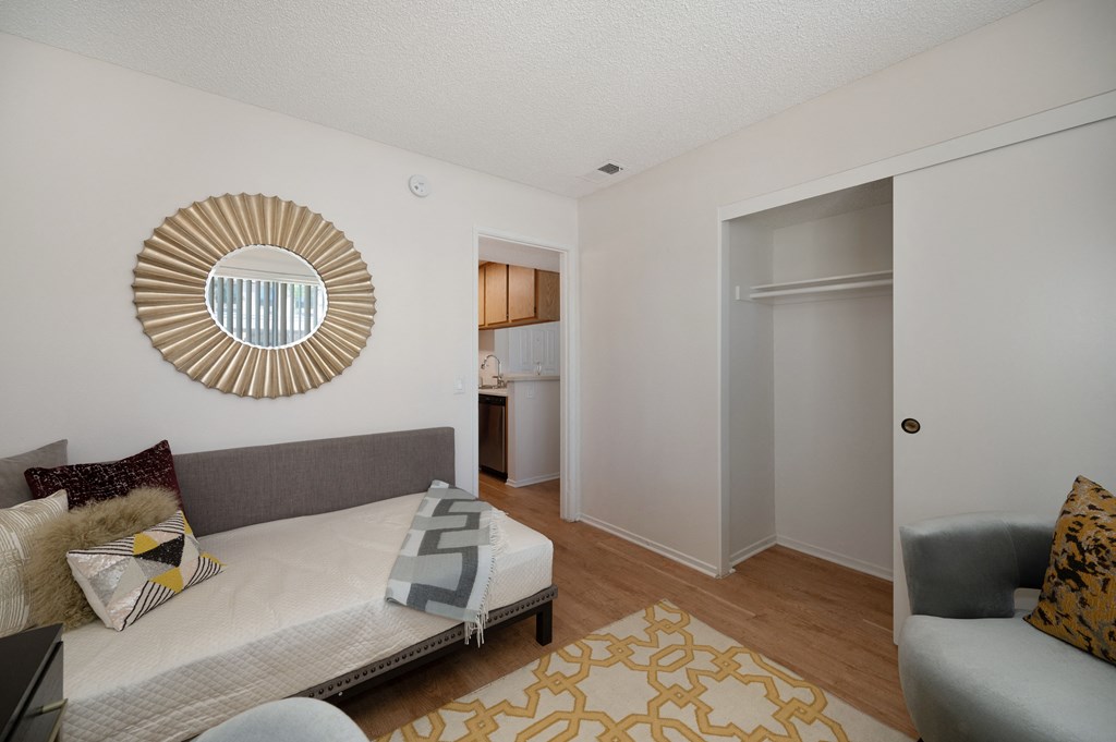 a living room with a couch and a door to a bathroom