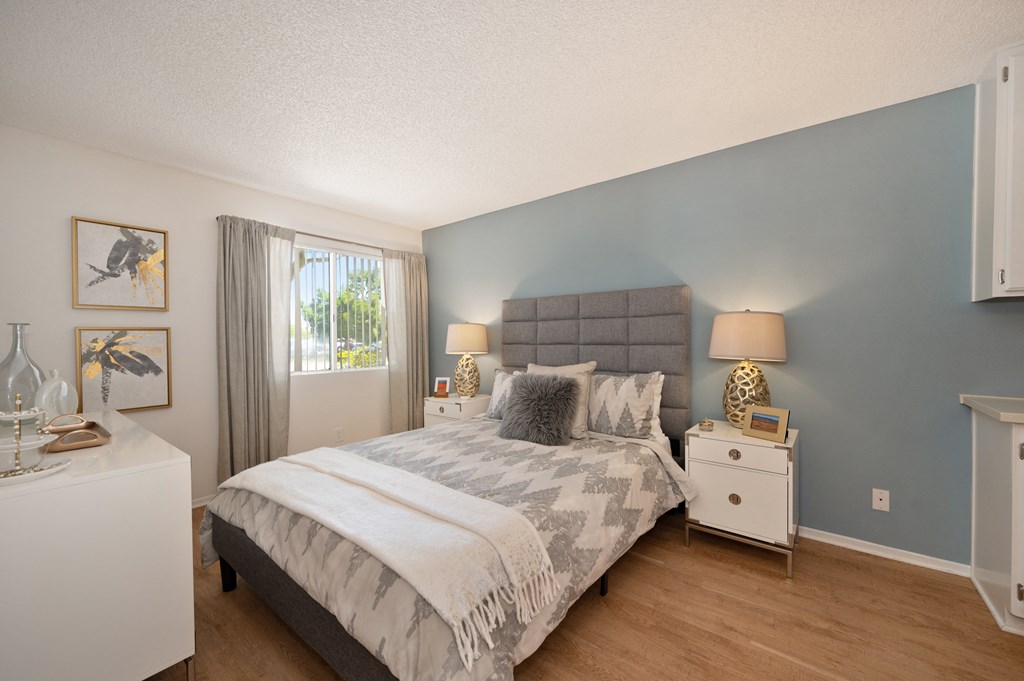 a bedroom with a bed and a dresser and a window