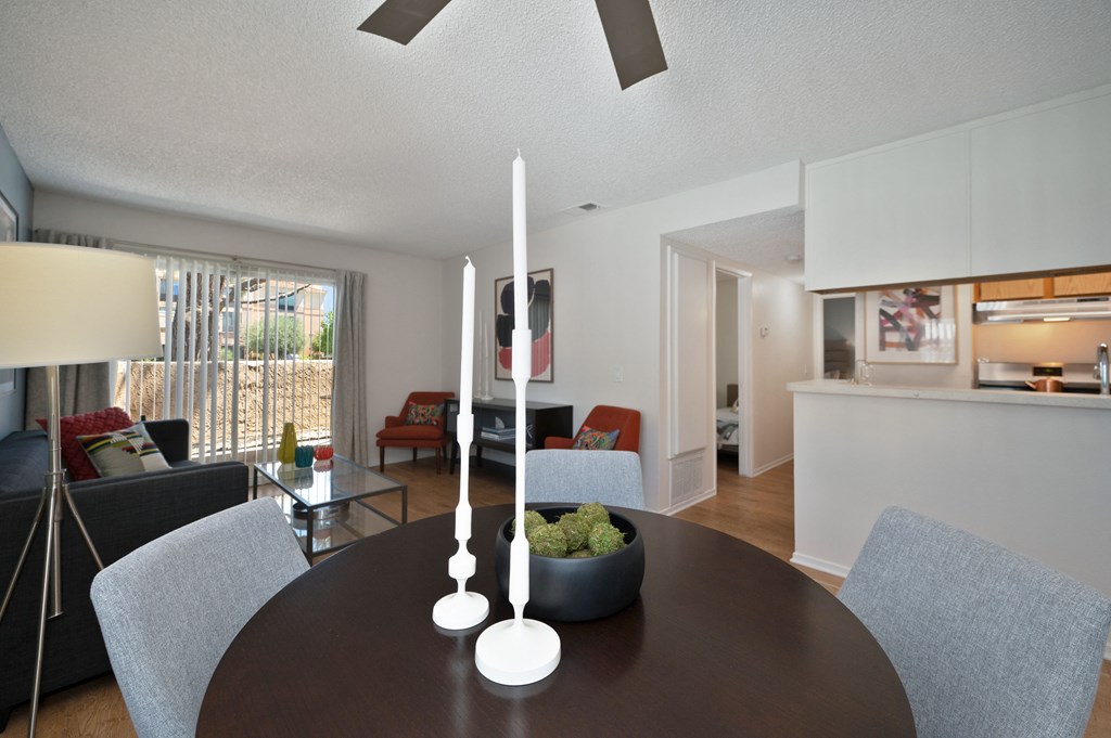 a living room and dining room with a table and chairs