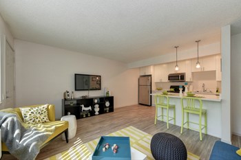 Living Room with Open Floor Plan Living Room with Hardwood Inspired Floors, Yellow/White Rug, Large Window with Blinds, Blue Sofa and Flat Screen Television - Photo Gallery 3