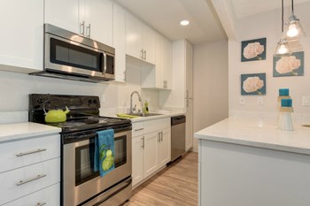 Kitchen with Hardwood Inspired Floors Kitchen with Hardwood Inspired Floors, , Refrigerator, White Cabinets and Small White Flower Paintings - Photo Gallery 6