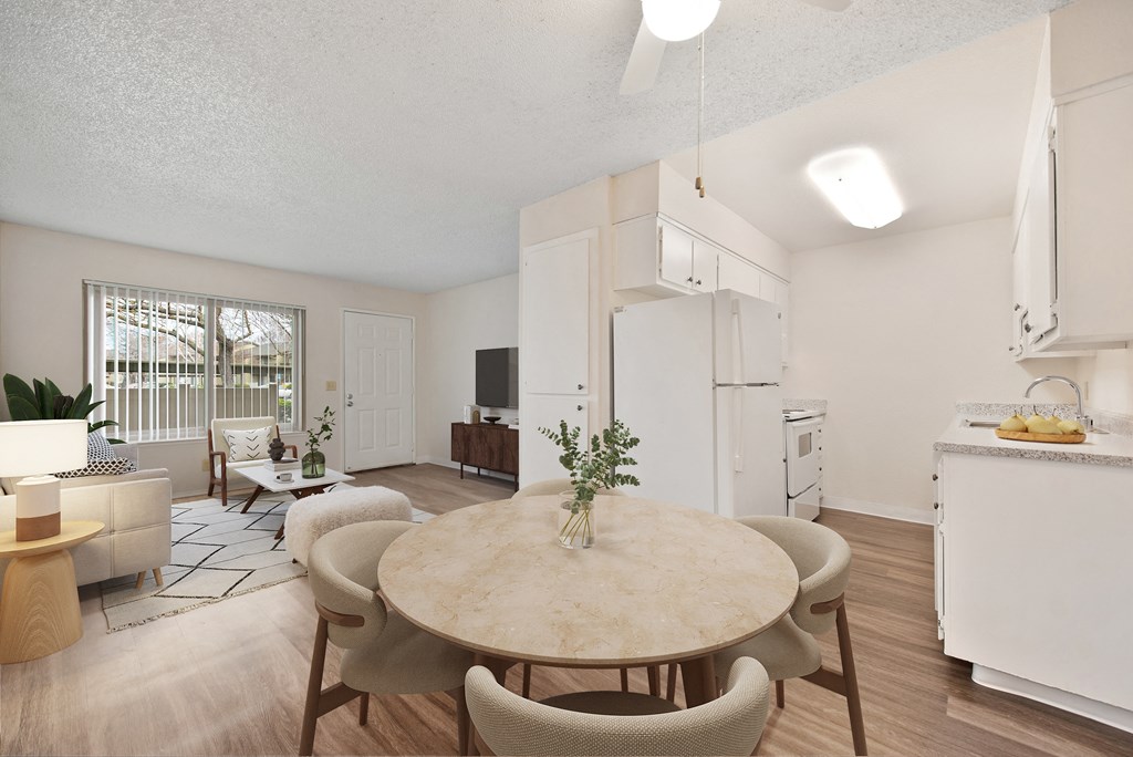 a living room and dining room with a table and chairs