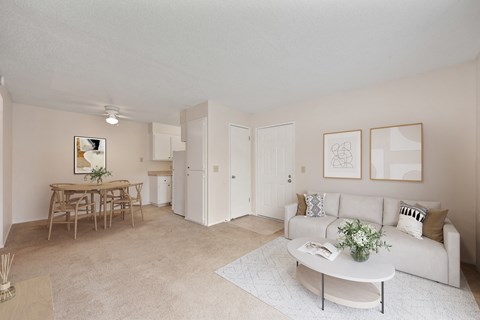 a living room and dining room with a couch and a table