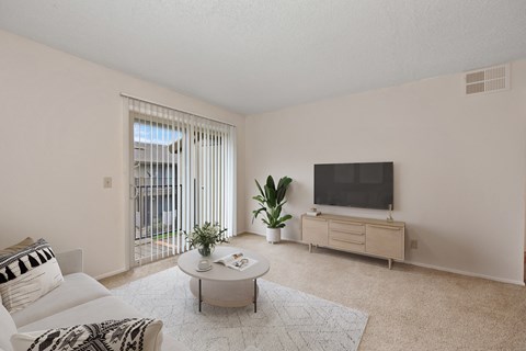 a living room with a couch and a table and a television