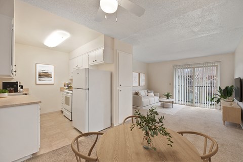 a living room with a dining room table and a kitchen