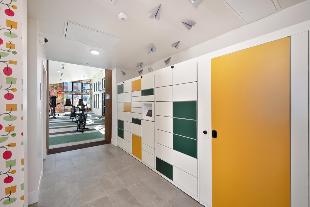 A hallway with a yellow door and a white wall with a pattern of squares and rectangles.
