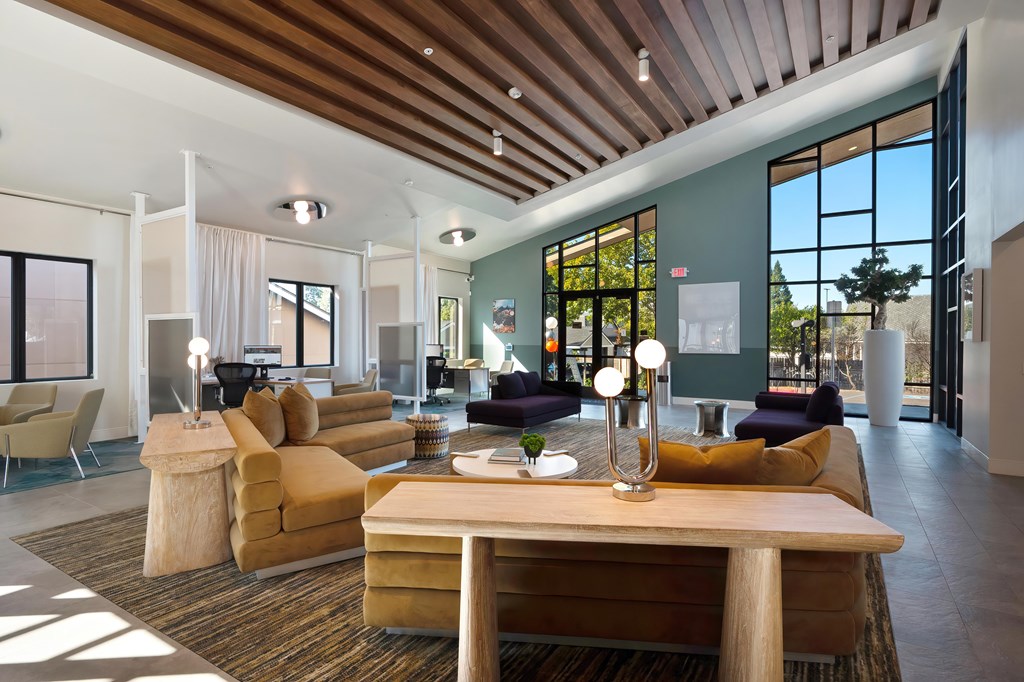 A modern living room with a wooden ceiling and furniture.