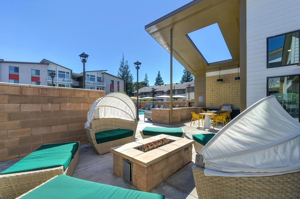A patio with a table and chairs under a white canopy.