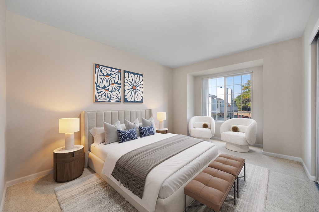 2 Bedroom, 2 Bath  Bedroom  with a large bed and a window area with two chairs