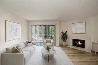 a living room with a white couch and coffee table in front of a fireplace
