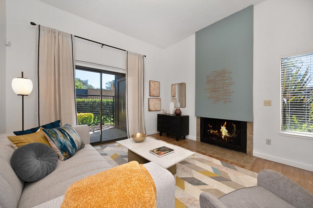 a living room with a couch coffee table and fireplace at Fountains of Fair Oaks, California, 95628