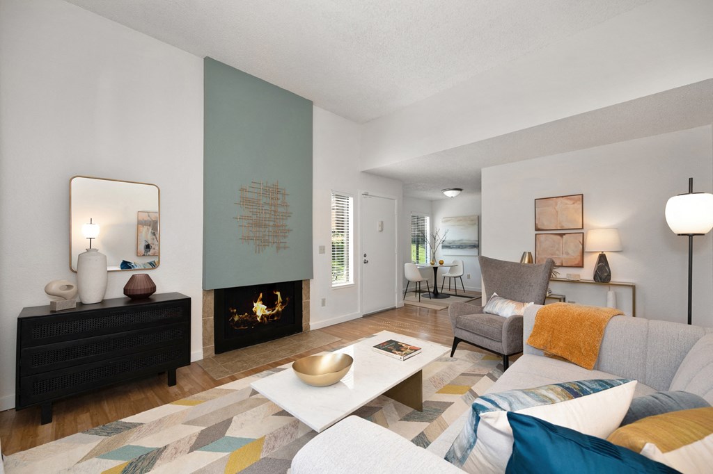a living room with a fireplace and a couch at Fountains of Fair Oaks, California