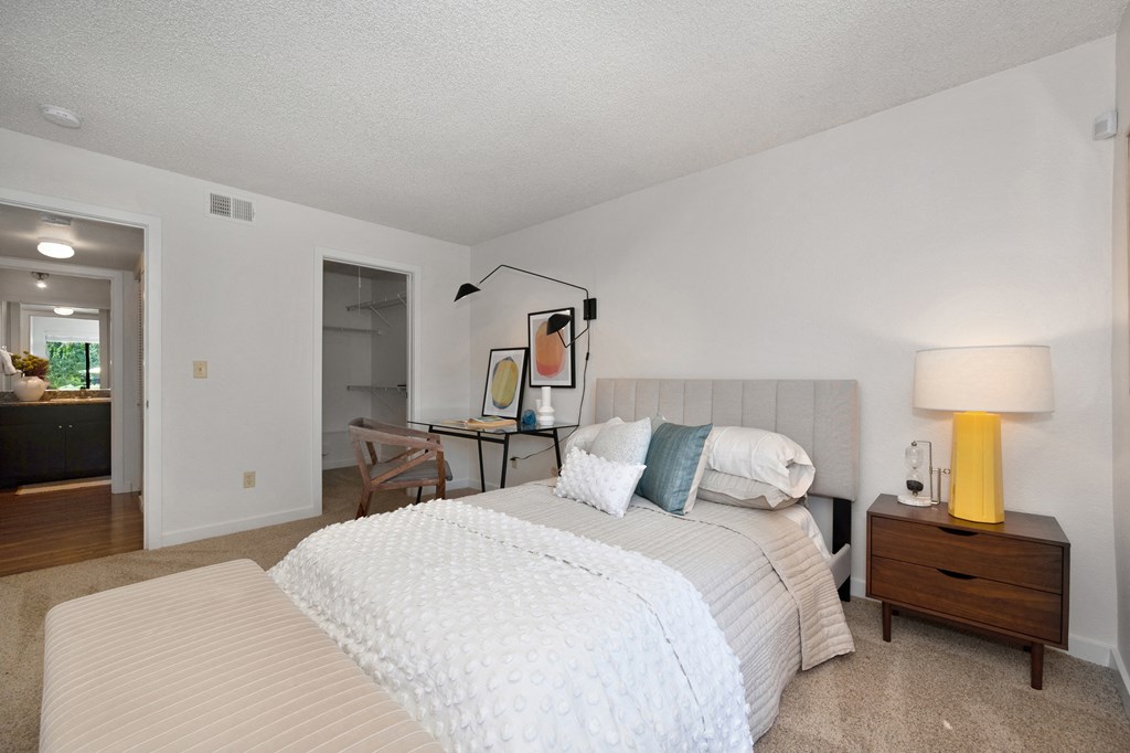 a bedroom with two beds and a desk with a lamp at Fountains of Fair Oaks, Fair Oaks, CA