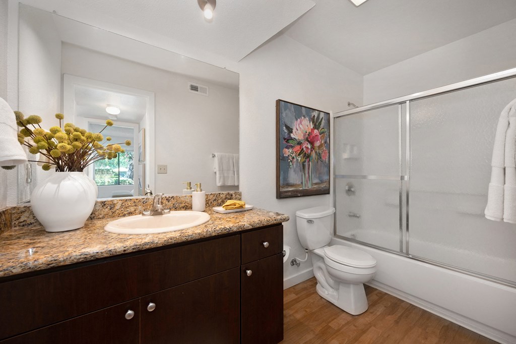 a bathroom with a toilet sink and shower at Fountains of Fair Oaks, Fair Oaks California