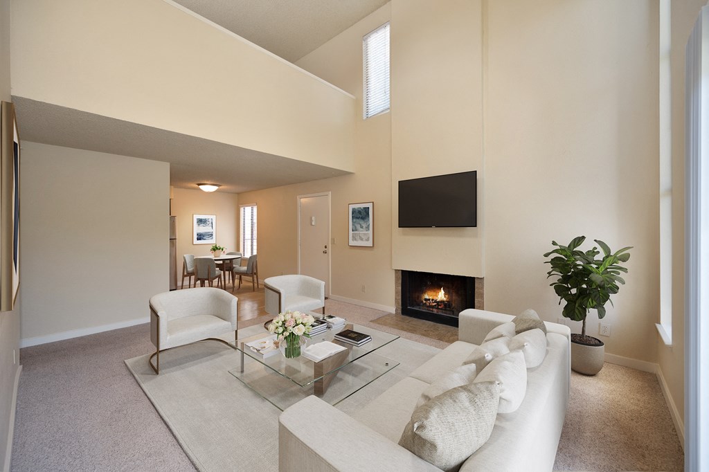 a living room with a couch and a table and a fireplace at Fountains of Fair Oaks, California