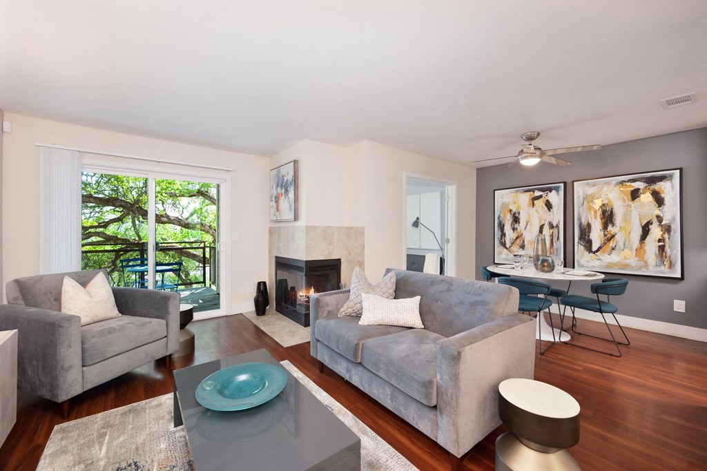 a living room with a fireplace and a couch at Folsom Ranch Apartments in California at Folsom Ranch, California