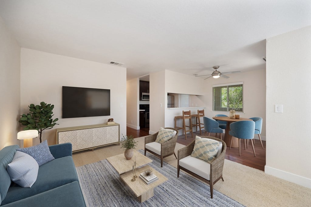 a living room and dining room with a couch and chairs and a television at Folsom Ranch, Folsom, California