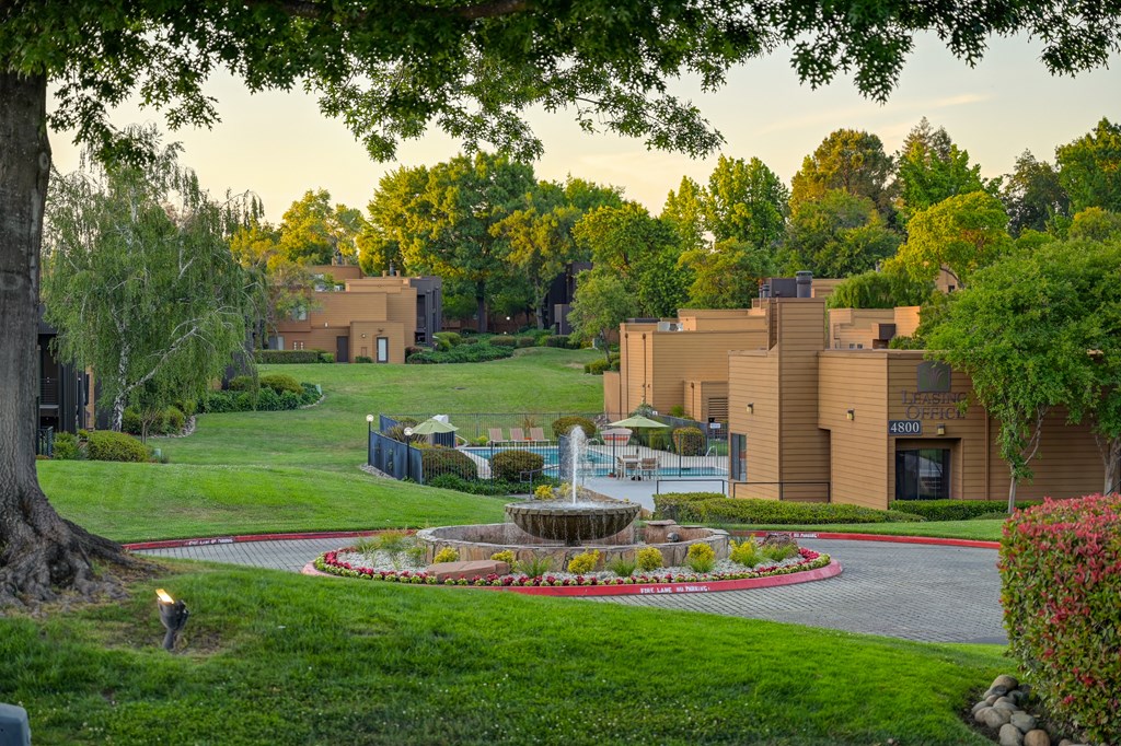 A building with a fountain in front of it.