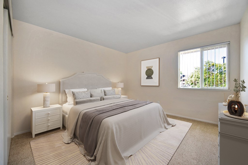 a bedroom with a bed and a window