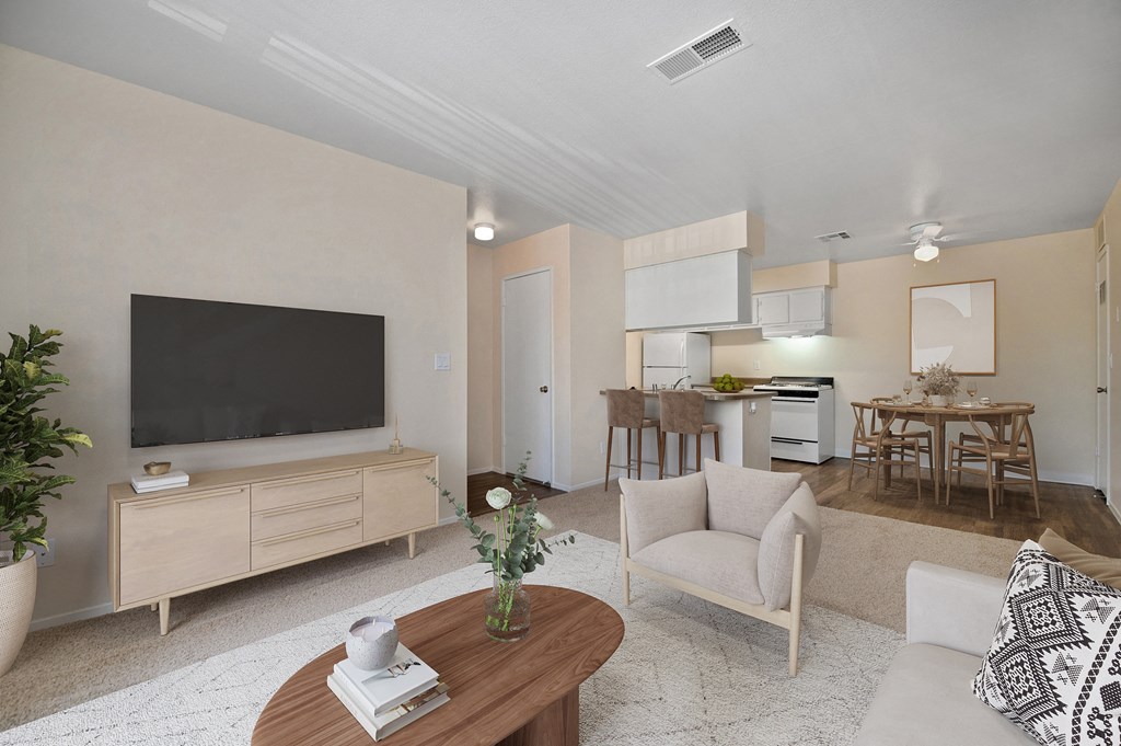 a living room with a tv and a table with a chair