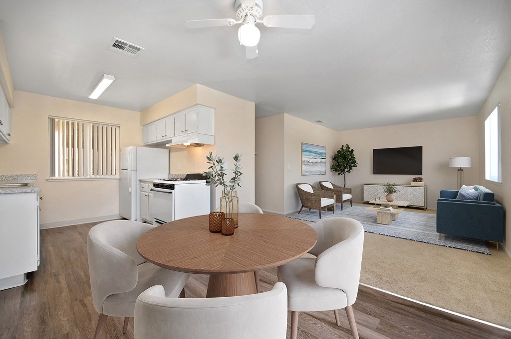 a living room with a dining room table and chairs