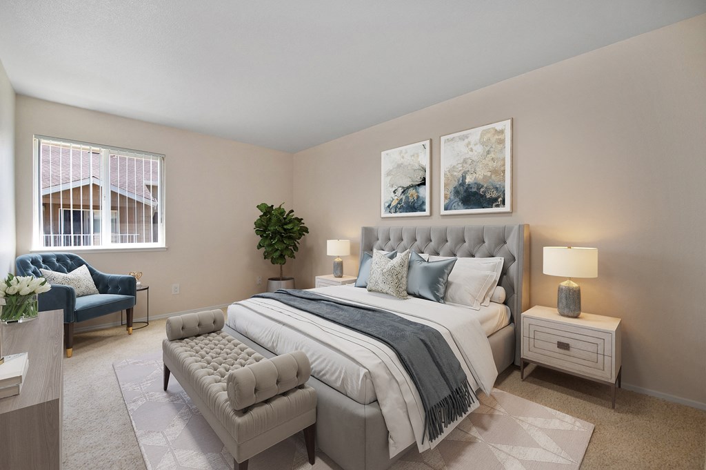 a bedroom with a bed and a chair and a window