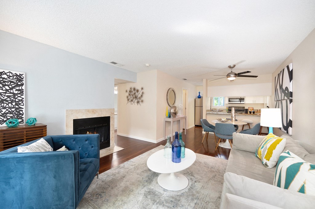 Living area with fireplace and dining area at Hidden Oaks Apartments, Citrus Heights