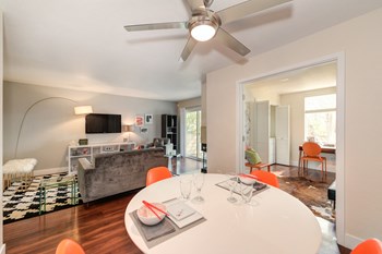 Dinning area with white round table. Views of the living room and into the loft room from the dining area. - Photo Gallery 6