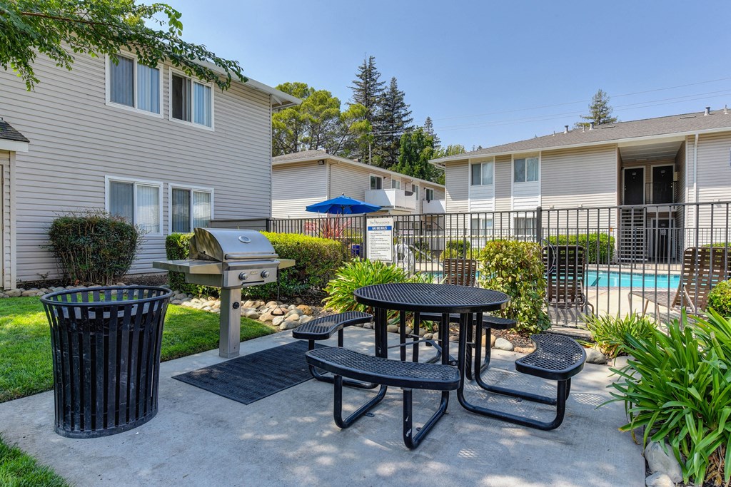 Outdoor BBQ and picnic area outside of the gated pool area.at The Renaissance Apartments, Citrus Heights, 95610