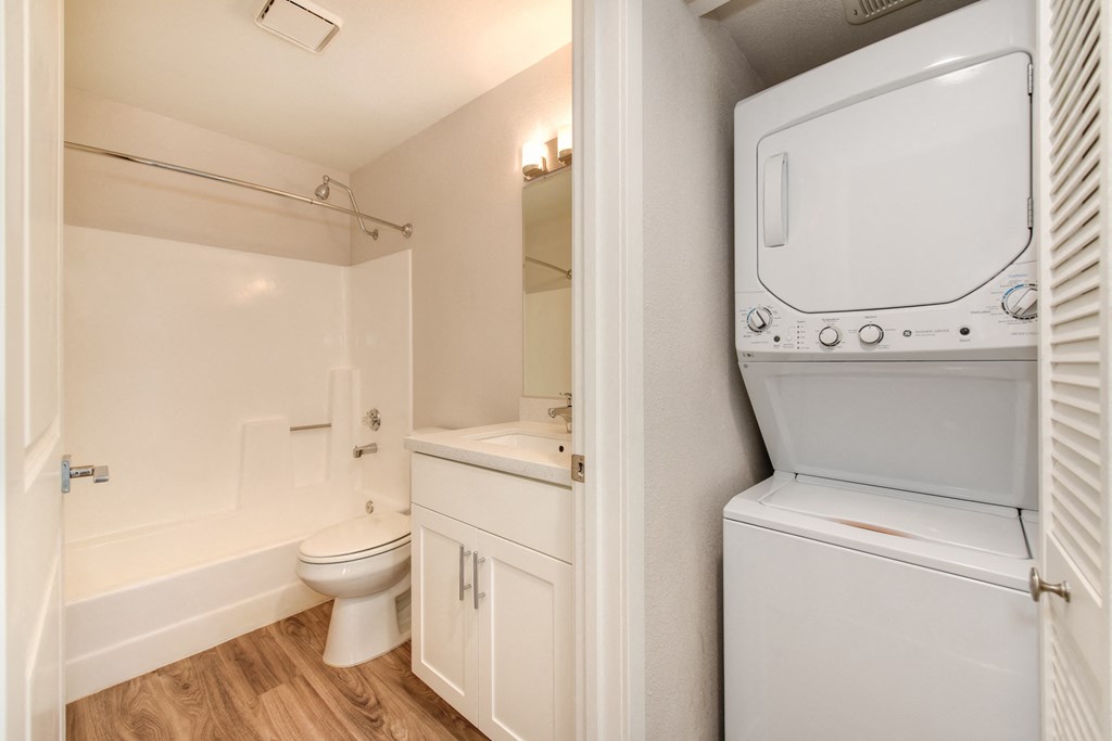 a bathroom with a washer and dryer inside apartment home.