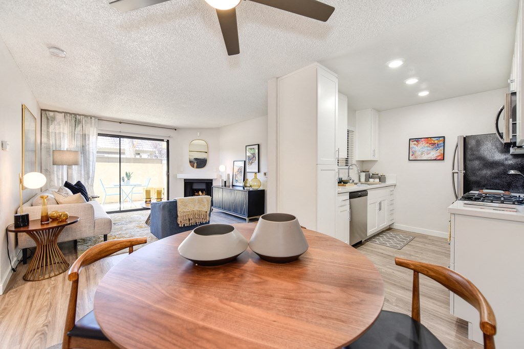 a living room and dining room with a table and a kitchen