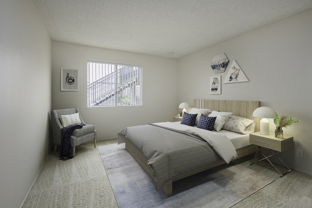 a bedroom with a bed and a chair and a window