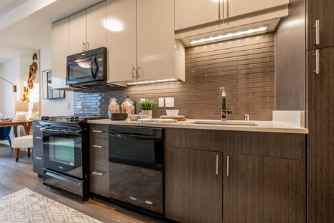 a kitchen with a sink and a stove and a microwave