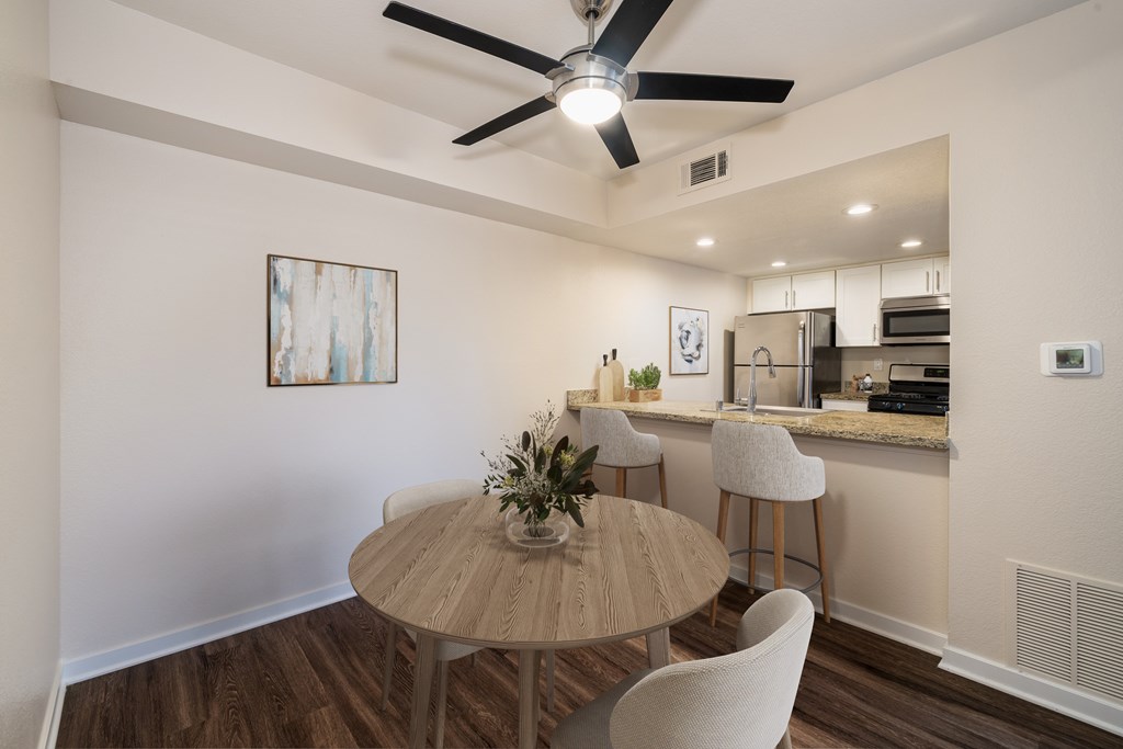 A dining area with a table and chairs.