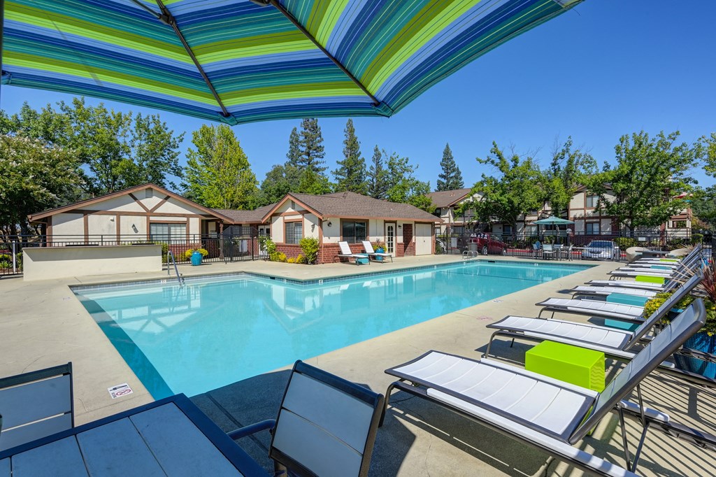 Pool Area take a dip in our resort style swimming pool with lounge chairs and umbrellas at Rocklin Manor Apartments, Rocklin ,California, 95677
