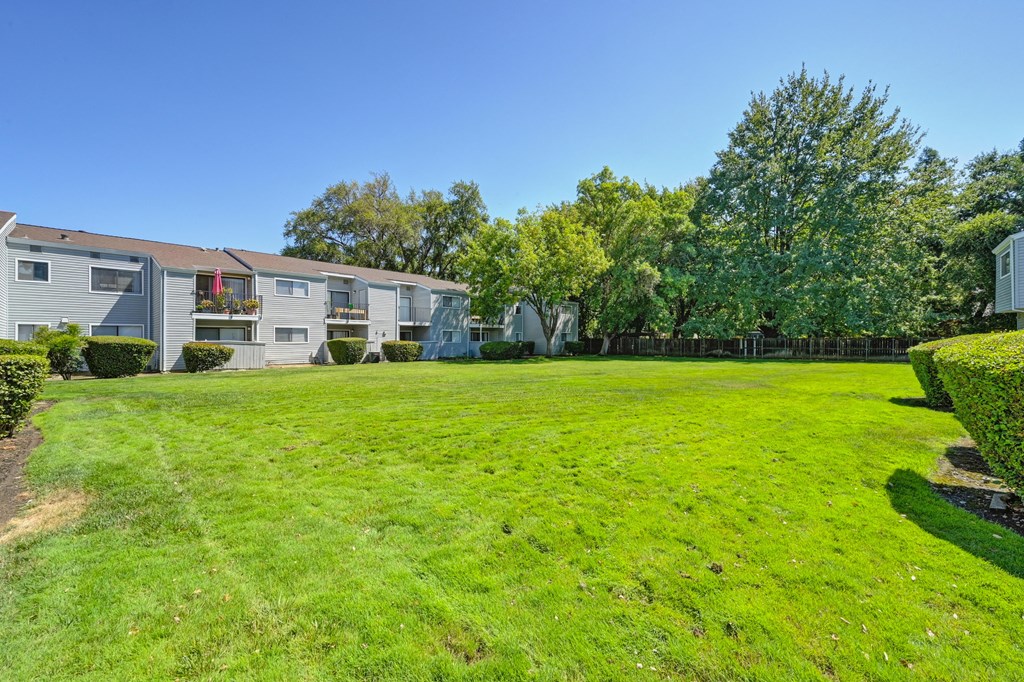 a large green lawn in front of some apartment buildings at Silverstone Apartments, California, 95618