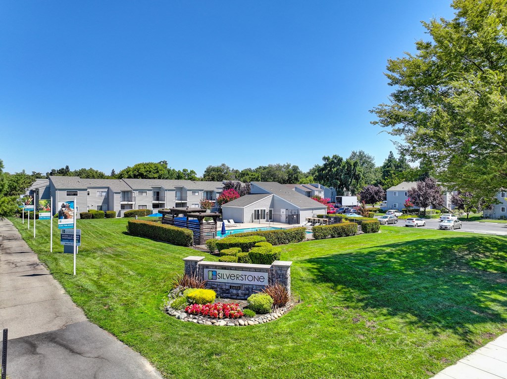 a view of a neighborhood with houses and a sign in the grass at Silverstone Apartments, Davis, CA, 95618