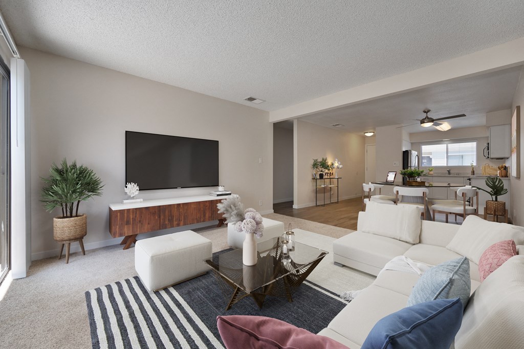a living room with a white couch and a television at Silverstone Apartments, Davis