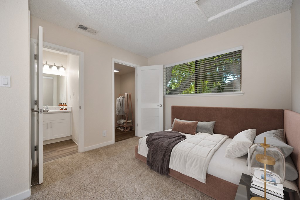 a bedroom with a large bed and a bathroom with a shower at Silverstone Apartments, California