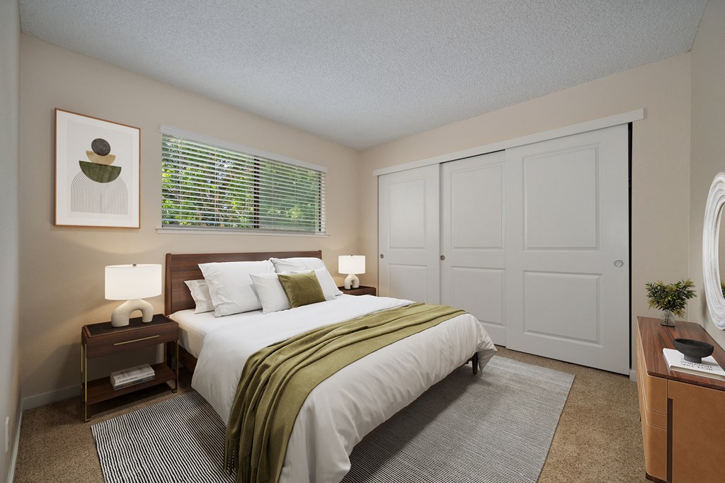 a bedroom with a large bed and a window at Silverstone Apartments, California