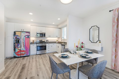 an open kitchen and dining room with a table and chairs