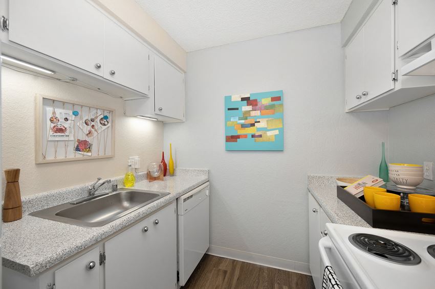 Kitchen a kitchen with white cabinets and a sink and a stove