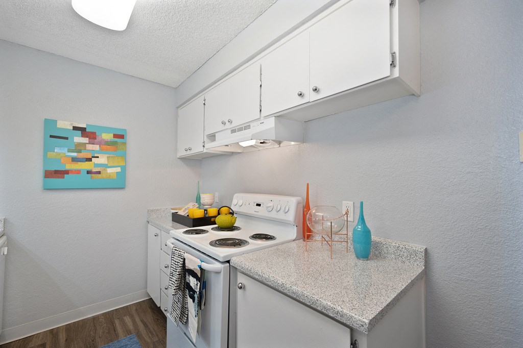 a kitchen with white appliances and a granite counter top