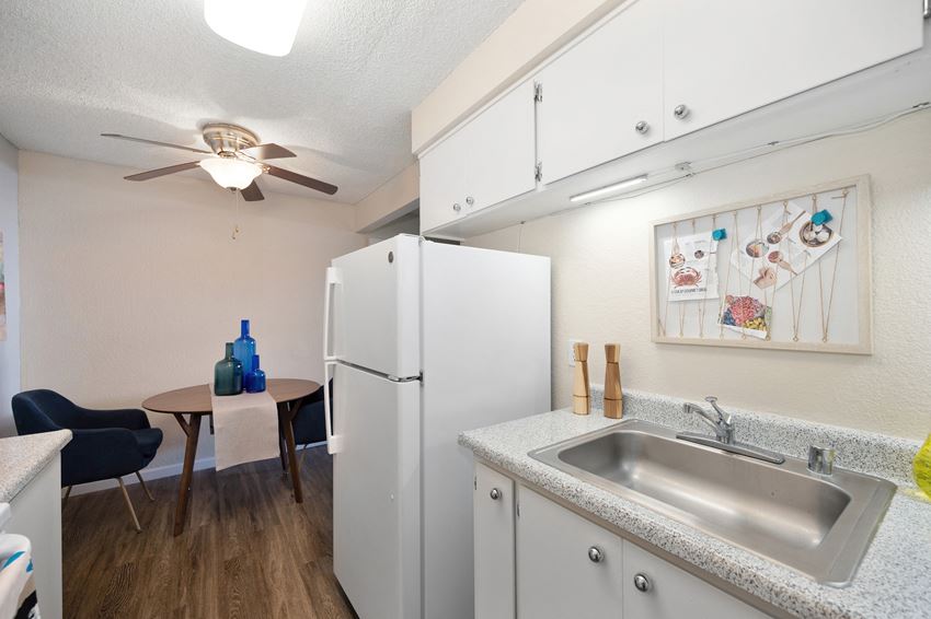 Kitchen and Dining a kitchen with a sink and a refrigerator and a ceiling fan