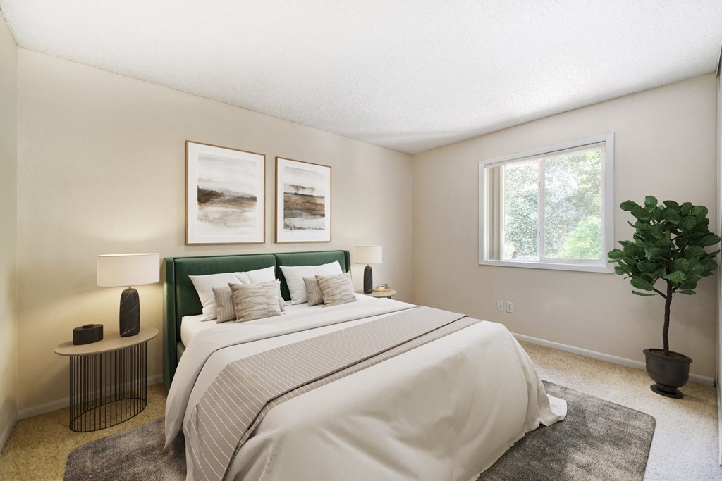 A bedroom with a large bed and a green headboard.