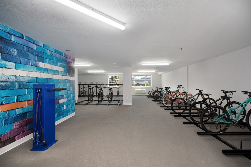 the club room has bikes parked in front of a colorful brick wall with a mosaic