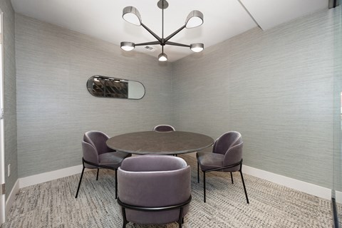 a meeting room with a table and chairs and a chandelier  at Track 281 Apartments, California, 95811