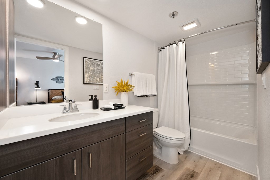 a bathroom with a sink and a shower and a toilet  at Track 281 Apartments, California, 95811
